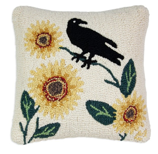 Primitive hooked pillow with black crow and yellow sunflowers on a cream background