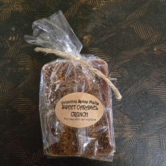 Packaged sweet garamels with a label on a textured dark surface
