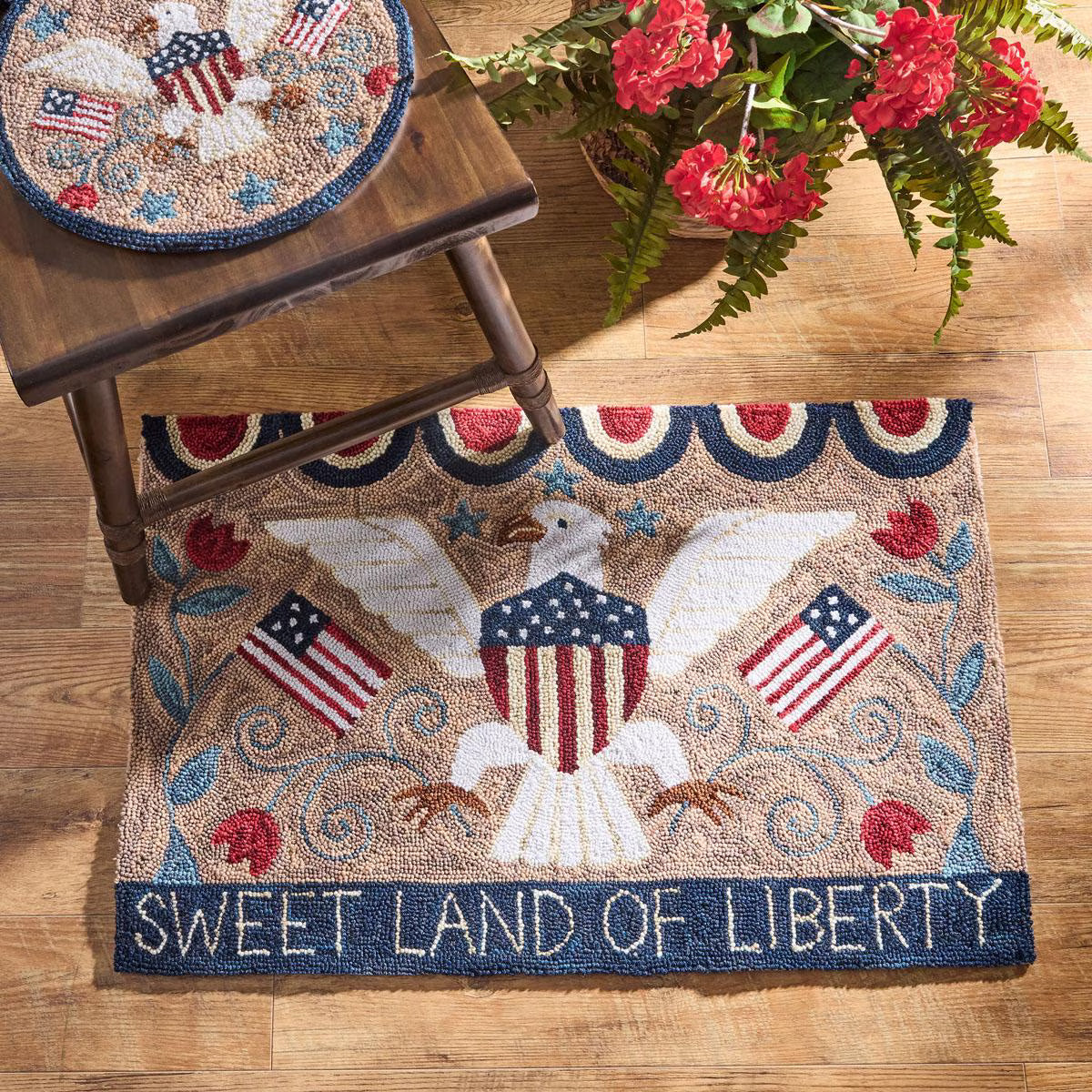 Decorative rug with an eagle and American flags design on a wooden floor.