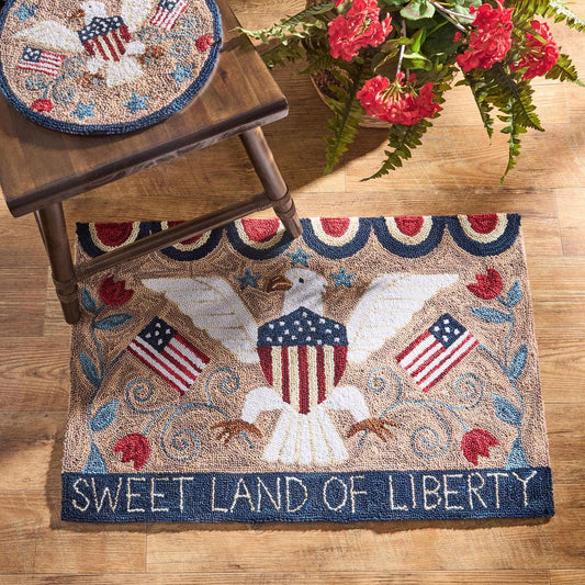 Decorative rug with an eagle and American flags design on a wooden floor.
