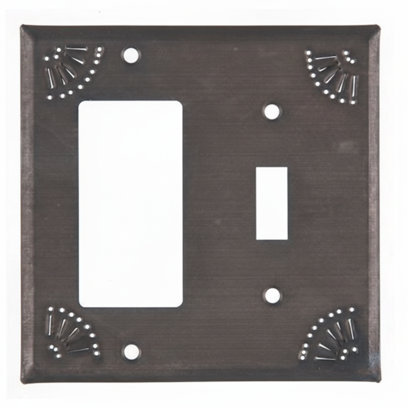 Decorative metal wall plate with two switch slots on a white background