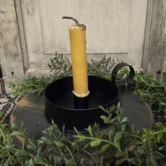 Candle pan with beeswax candle on textured black riser