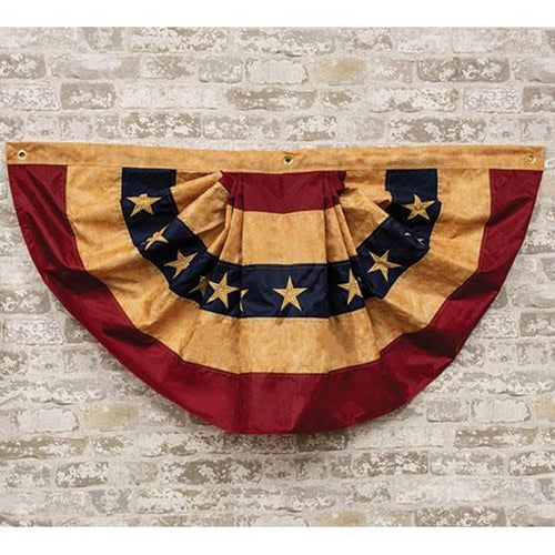 Decorative flag with red, blue, and gold colors on a brick wall background