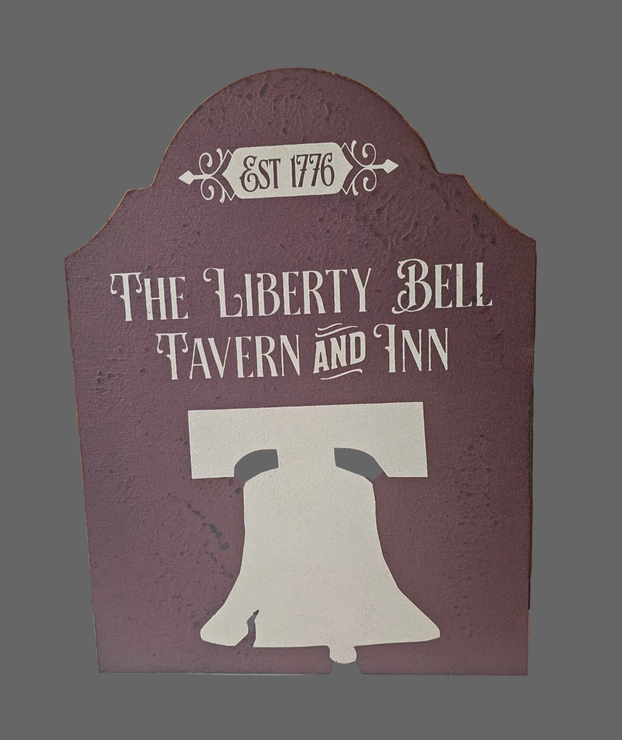 Decorative sign for 'The Liberty Bell Tavern and Inn' with a silhouette of the Liberty Bell on a wooden background.
