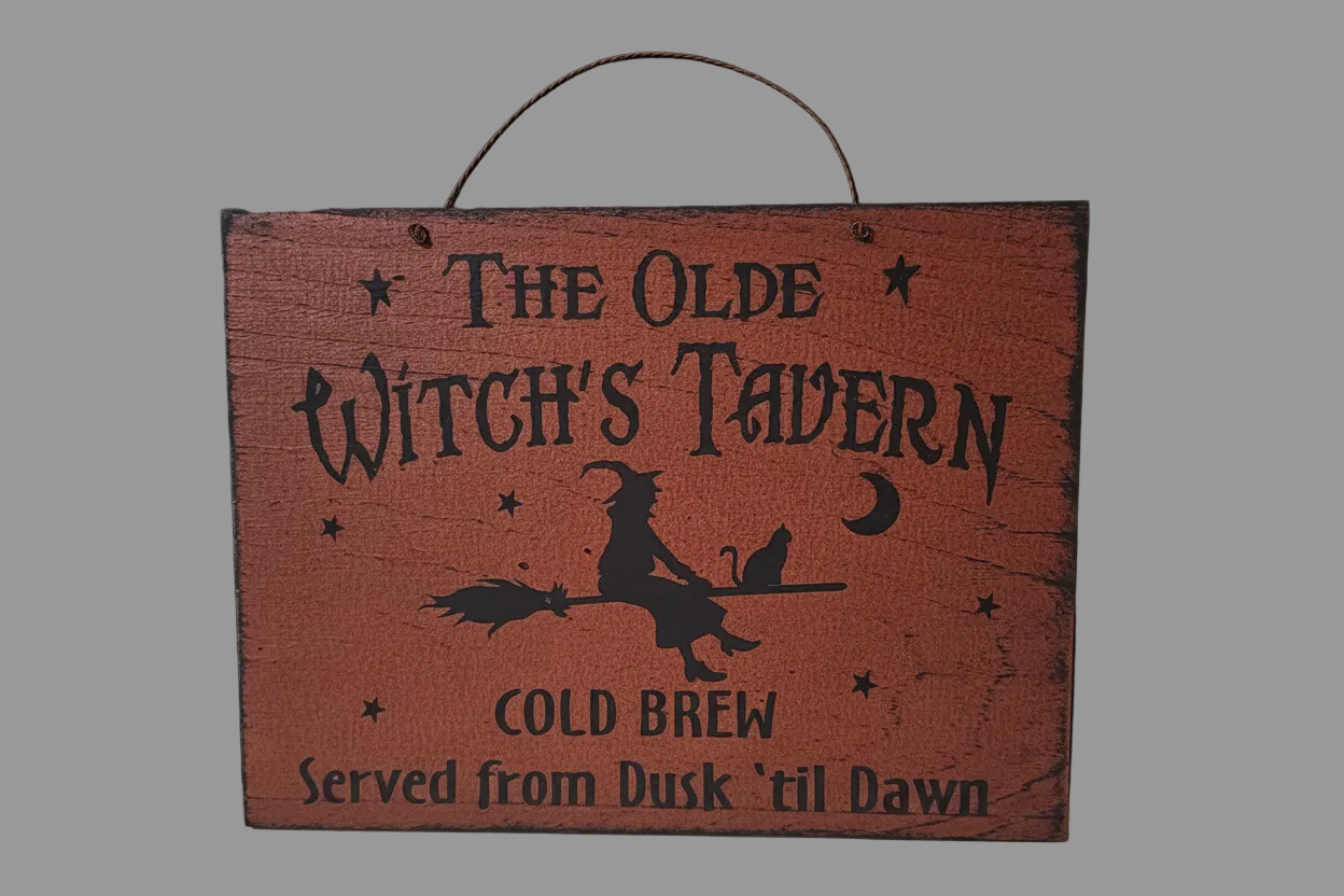 Wooden sign with 'The Olde Witch's Tavern' text and a silhouette of a witch on a broomstick.