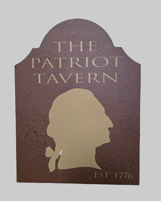 Sign for 'The Patriot Tavern' with a silhouette of a man's head on a wooden background