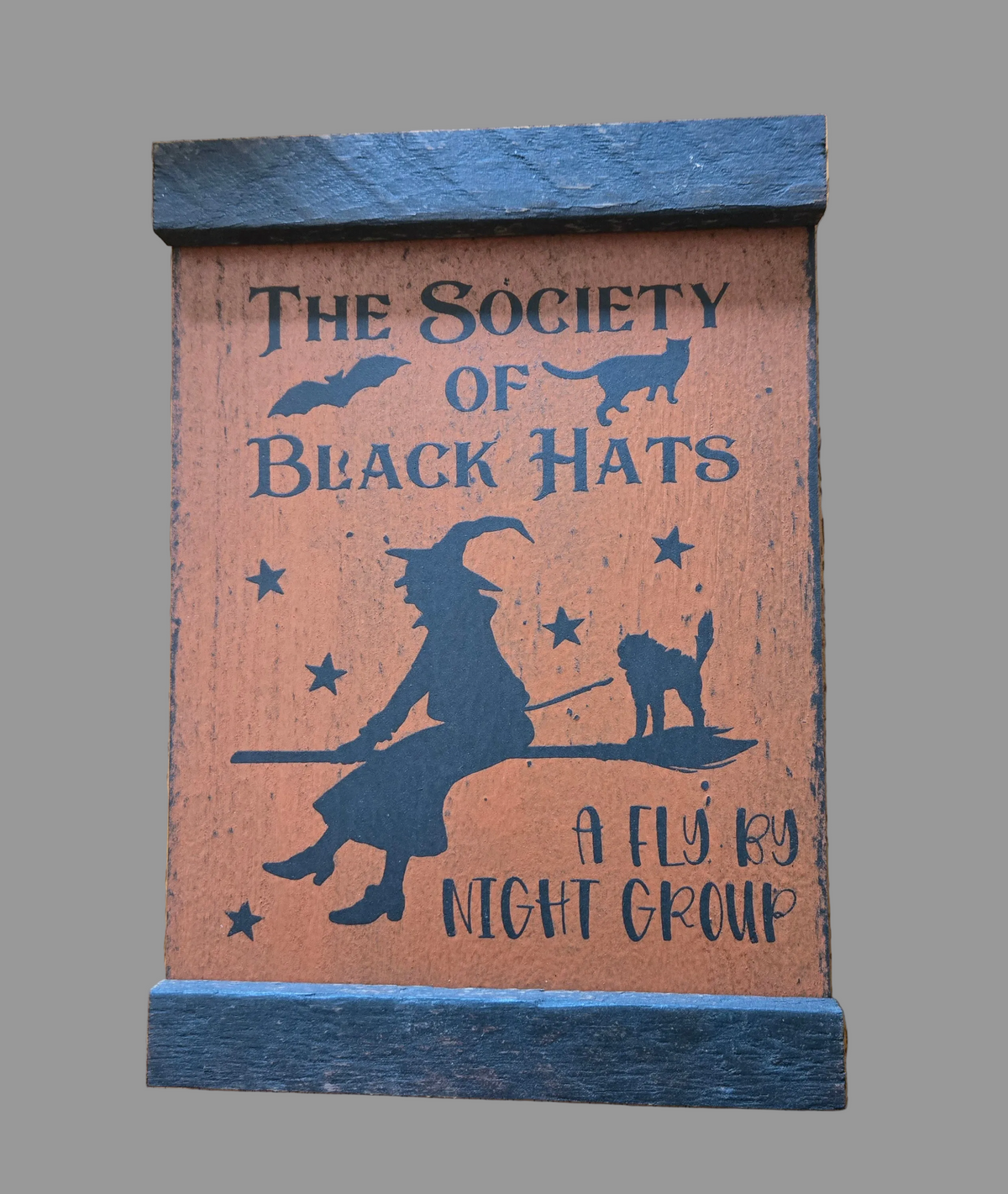 Wooden sign with 'The Society of Black Hats' text and witch silhouette on a gray background
