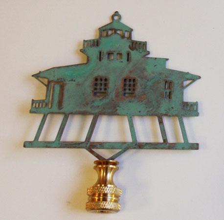 Verdigris lamp finial with a harbor building design