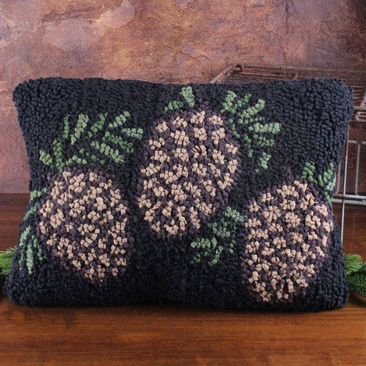 Decorative pillow with woven pattern on a wooden surface