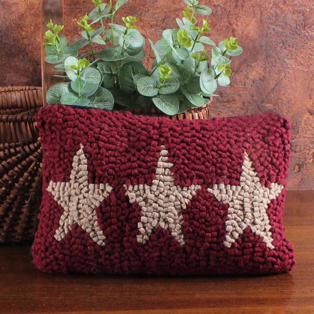 Decorative pillow with star pattern on a wooden surface