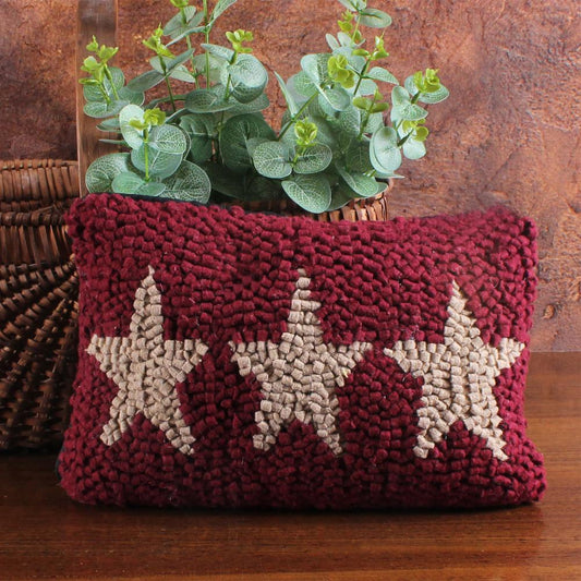 Decorative pillow with star pattern on a wooden surface