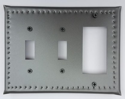 A tin double switch/single ground fault border punch, featuring a gray metal plate with multiple mounting holes and two switch cut-outs.