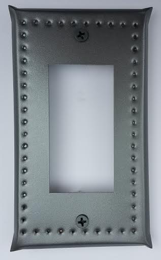 A gray metal single ground fault/breaker border punch outlet cover with a decorative pattern around the perimeter.