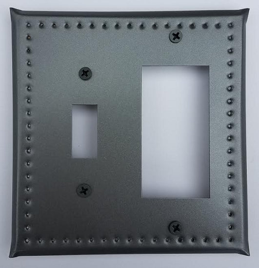A gray metal electrical border punch with a single switch and ground fault hole, featuring a tin construction with screws visible on the edges.