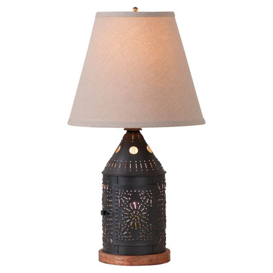 Decorative table lamp with a textured black base and beige lampshade on a white background