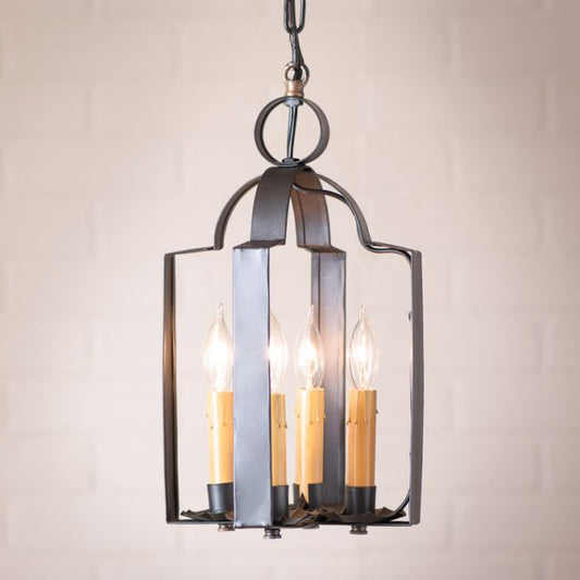 Decorative pendant light fixture with four bulbs on a plain background