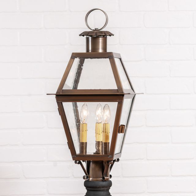 Bronze outdoor lantern with clear glass on a white background
