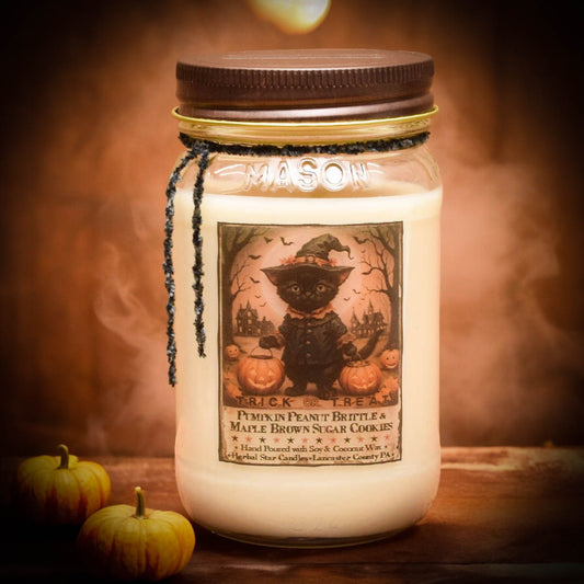 Mason jar candle with a Halloween-themed label and pumpkins on a wooden surface.