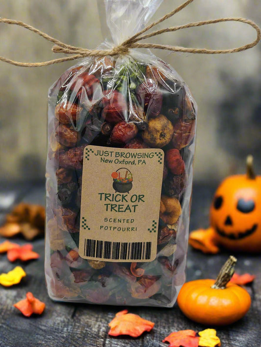 Bag of 'Trick or Treat' scented potpourri with a label on a gray background