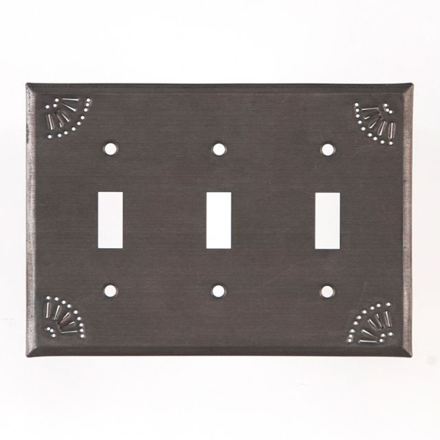 A black triple switch wall plate with a decorative chisel design around the edge.