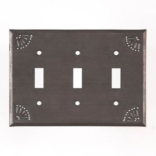 A black triple switch wall plate with a decorative chisel design around the edge.
