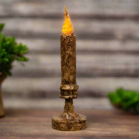 Decorative candle with a lit wick on a blurred background