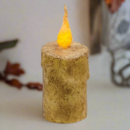 Candle with a small yellow candle on a neutral background