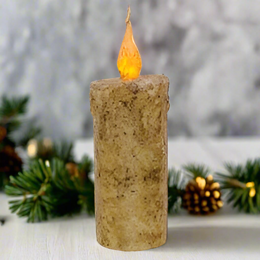 Decorative candle with a flame against a blurred natural background