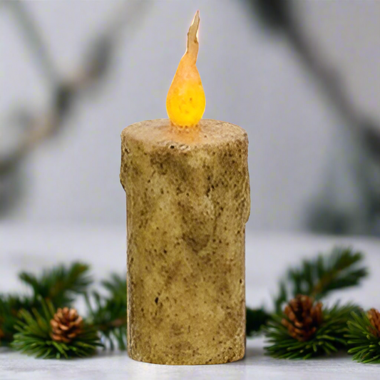 Faux candle with a textured base and flame on a white background