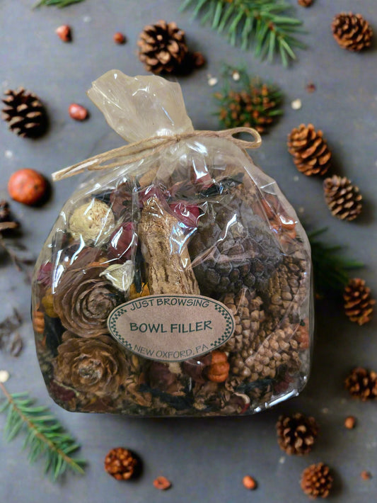 A clear plastic bag filled with various dried botanicals for bowl filling, secured with a twine knot at the top.