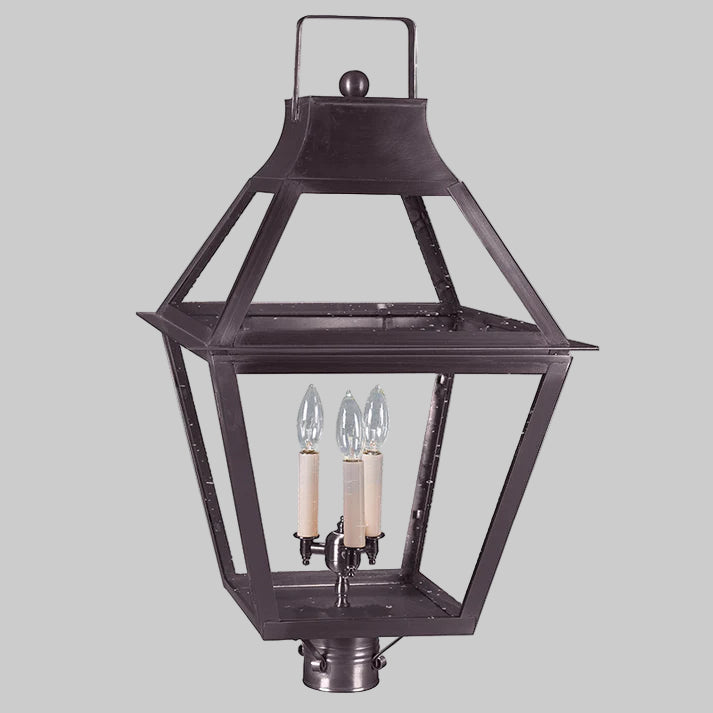 Traditional outdoor lantern with two candle-like lights on a gray background