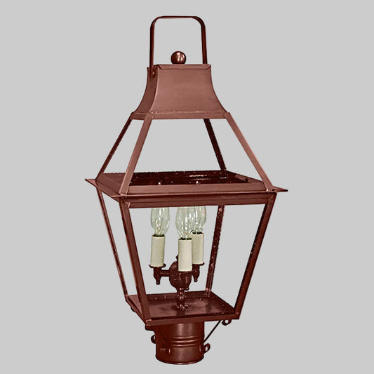 Copper outdoor post lamp with three light bulbs on a gray background