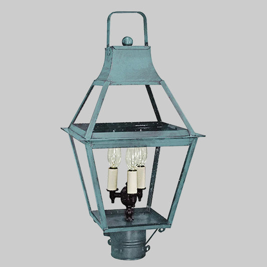 Vintage-style metal post lantern with three light bulbs on a gray background