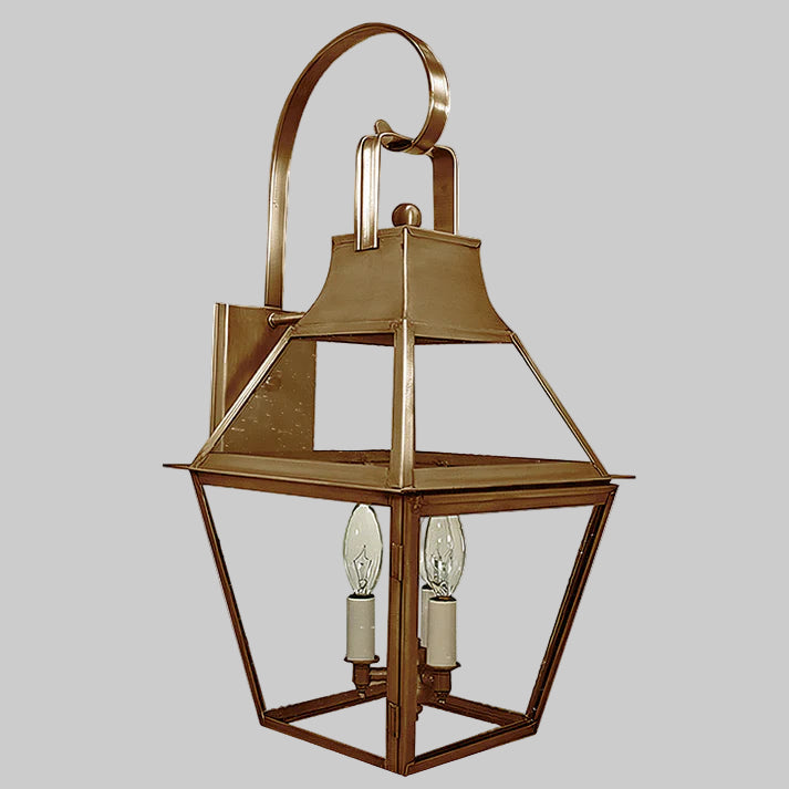 Bronze outdoor wall lantern with two light bulbs on a gray background