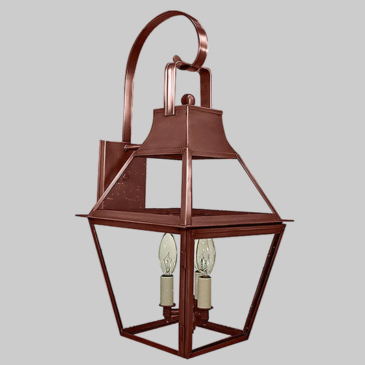 Bronze outdoor wall lantern with two light bulbs on a gray background