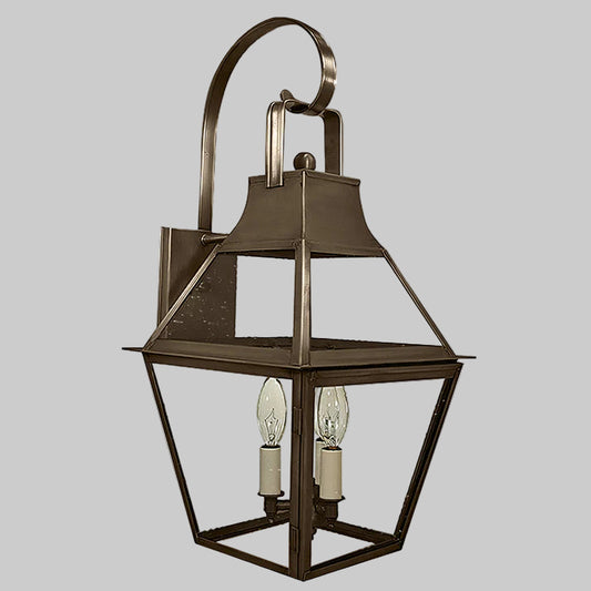 Bronze outdoor wall lantern with two light bulbs on a gray background