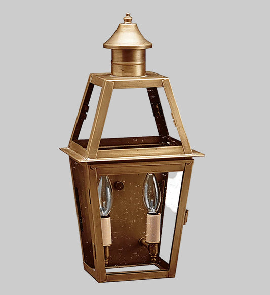 Brass outdoor lantern with two light bulbs on a gray background