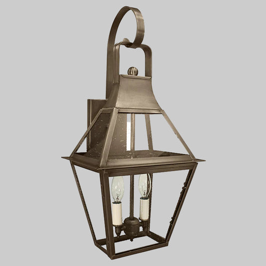 Bronze outdoor wall lantern with two light bulbs on a gray background