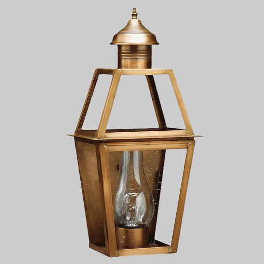 Brass lantern with glass shade on a white background