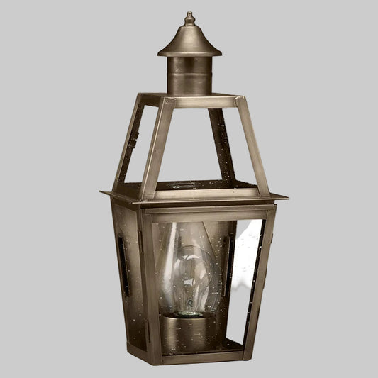 Brass outdoor lantern with clear glass on a white background