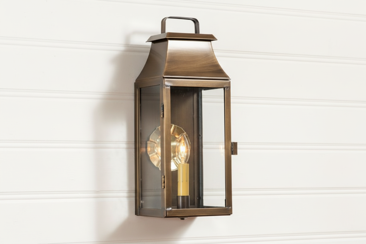 Bronze outdoor wall lantern on a white wooden panel background