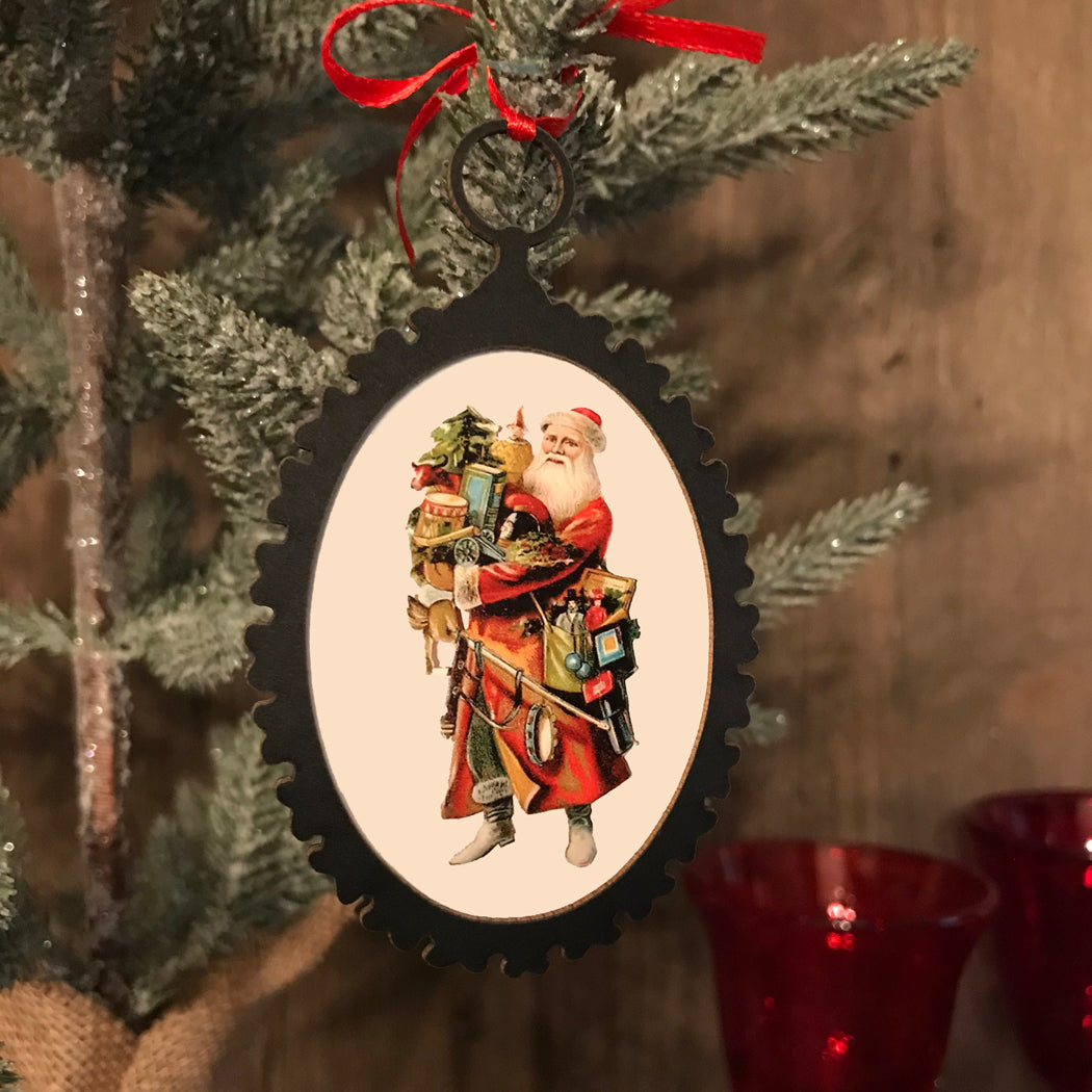 Decorative Christmas ornament with a vintage Santa Claus design on a tree.