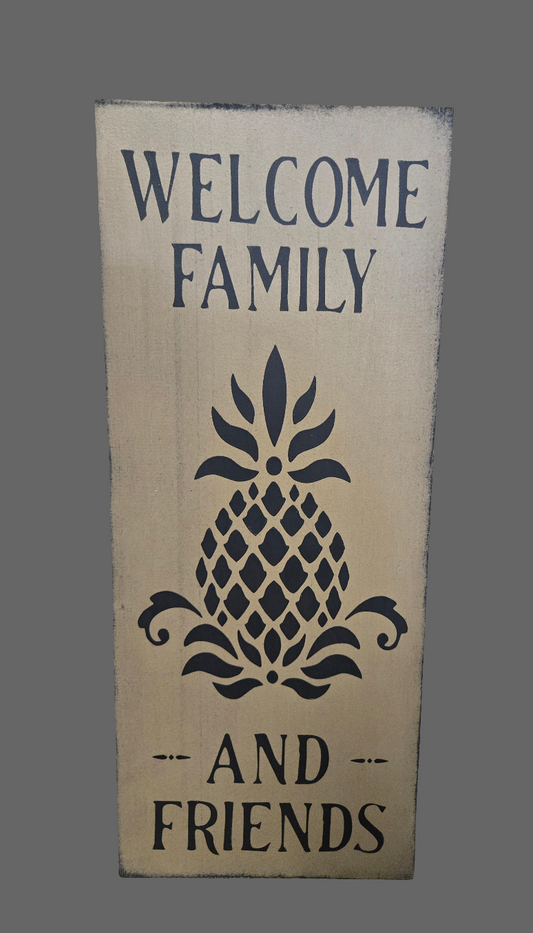 Wooden sign with 'Welcome Family and Friends' text and pineapple design on a gray background