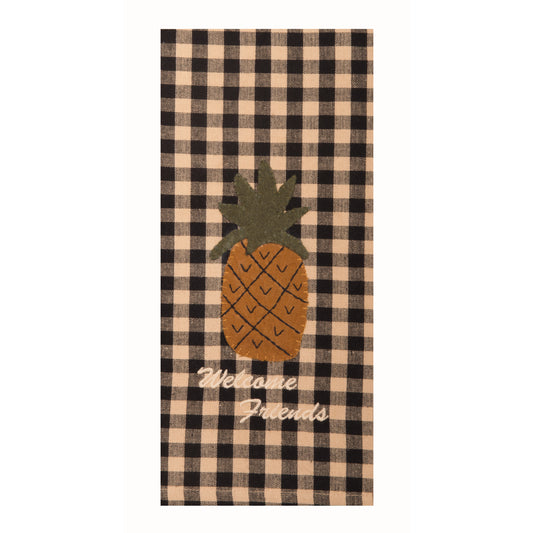 A towel with a black and white checkered pattern and a central design of a pineapple with the text 'Welcome Friends'.