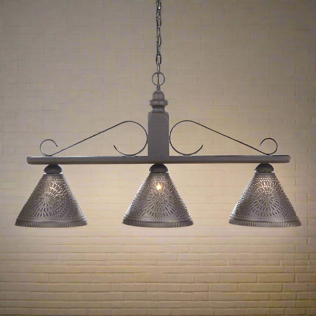 A black wrought iron hanging light with three Kettle Black shades, designed for use over an island or sink area in a kitchen.