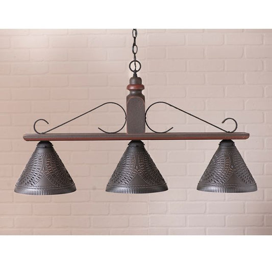 Vintage-style pendant light with three metal lampshades against a beige brick wall.