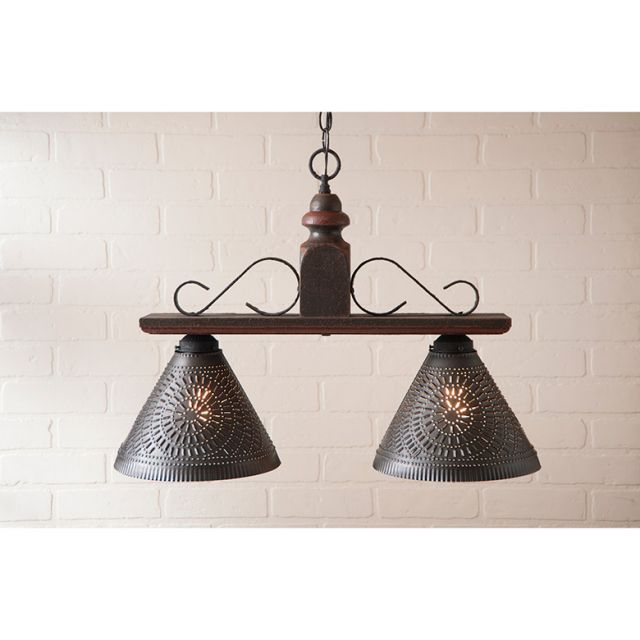 Vintage-style pendant light with two lampshades against a white brick wall.