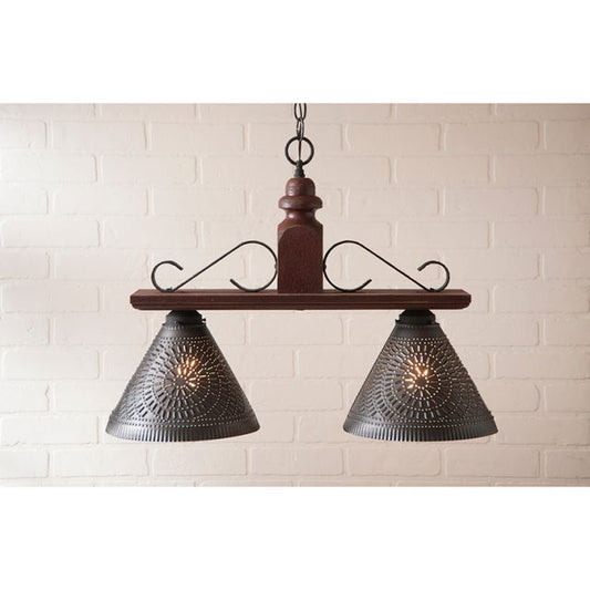 Vintage-style pendant light with wooden fixture and metal shades against a white brick wall.