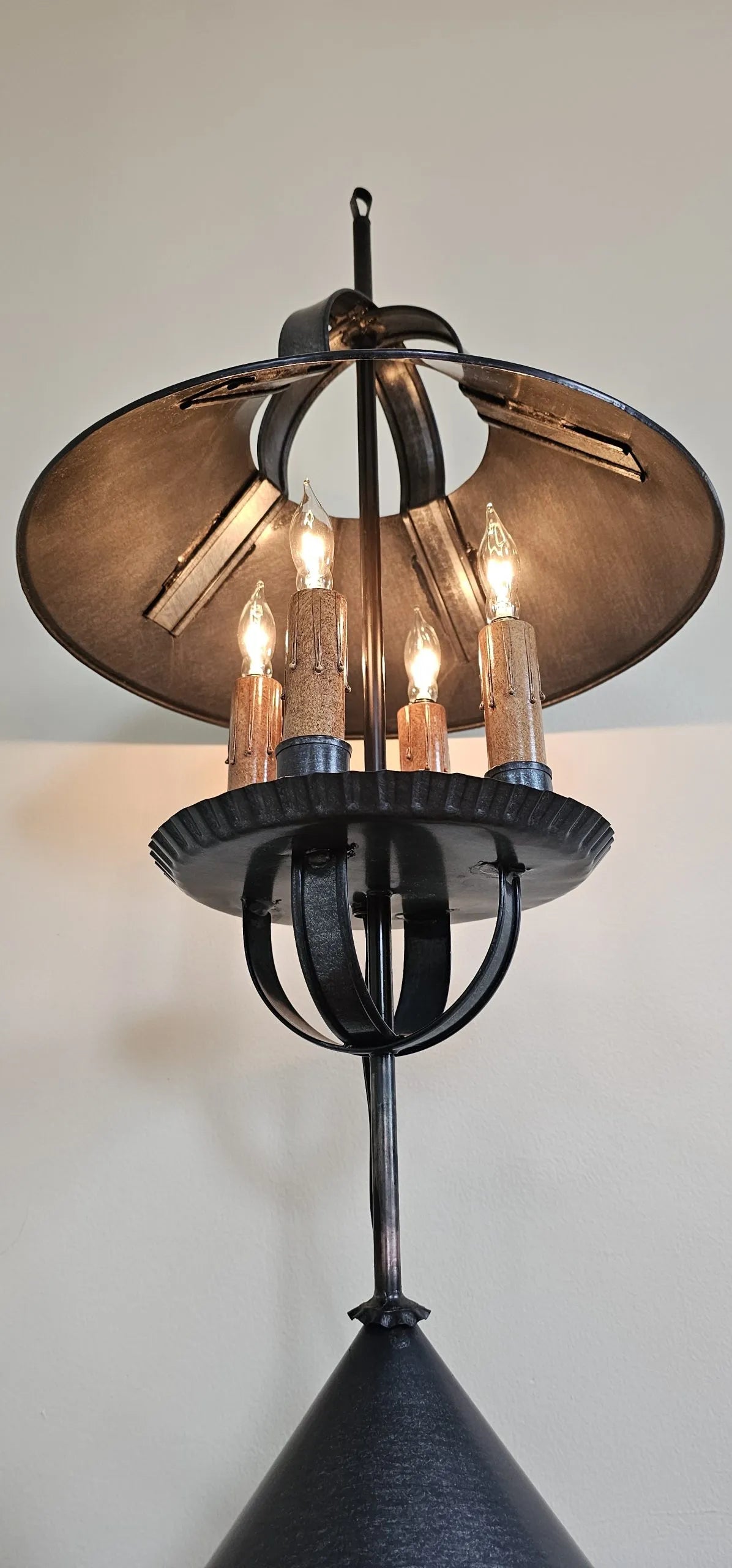 Decorative lamp with a black and bronze design on a white background