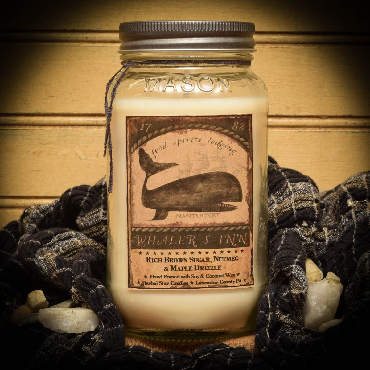 Mason jar candle labeled 'Whaler's Inn' with a decorative background